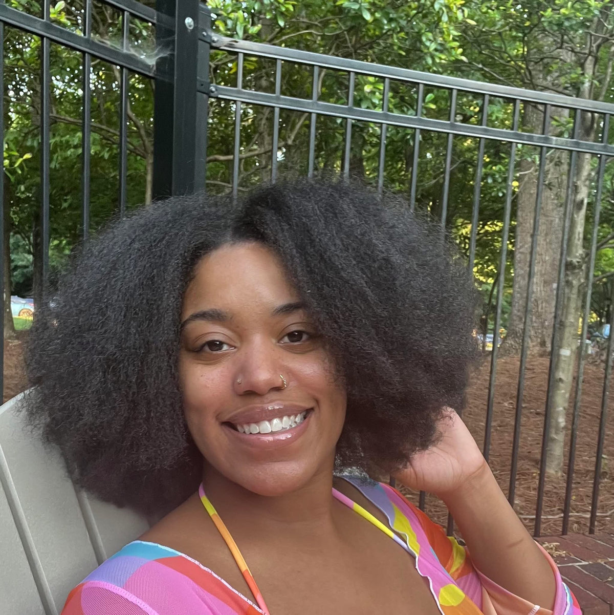 Picture of Myriah Yates smiling with her natural hair flowing