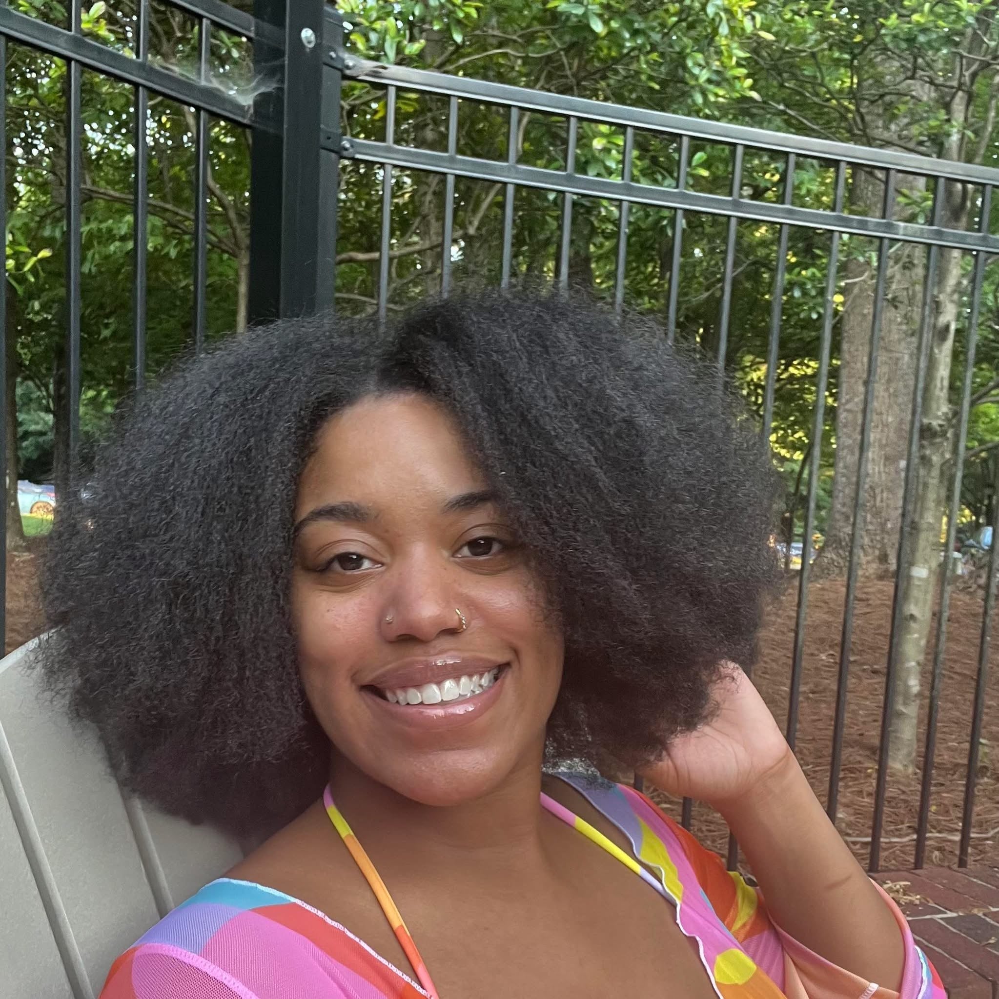 Picture of Myriah Yates smiling with her natural hair flowing