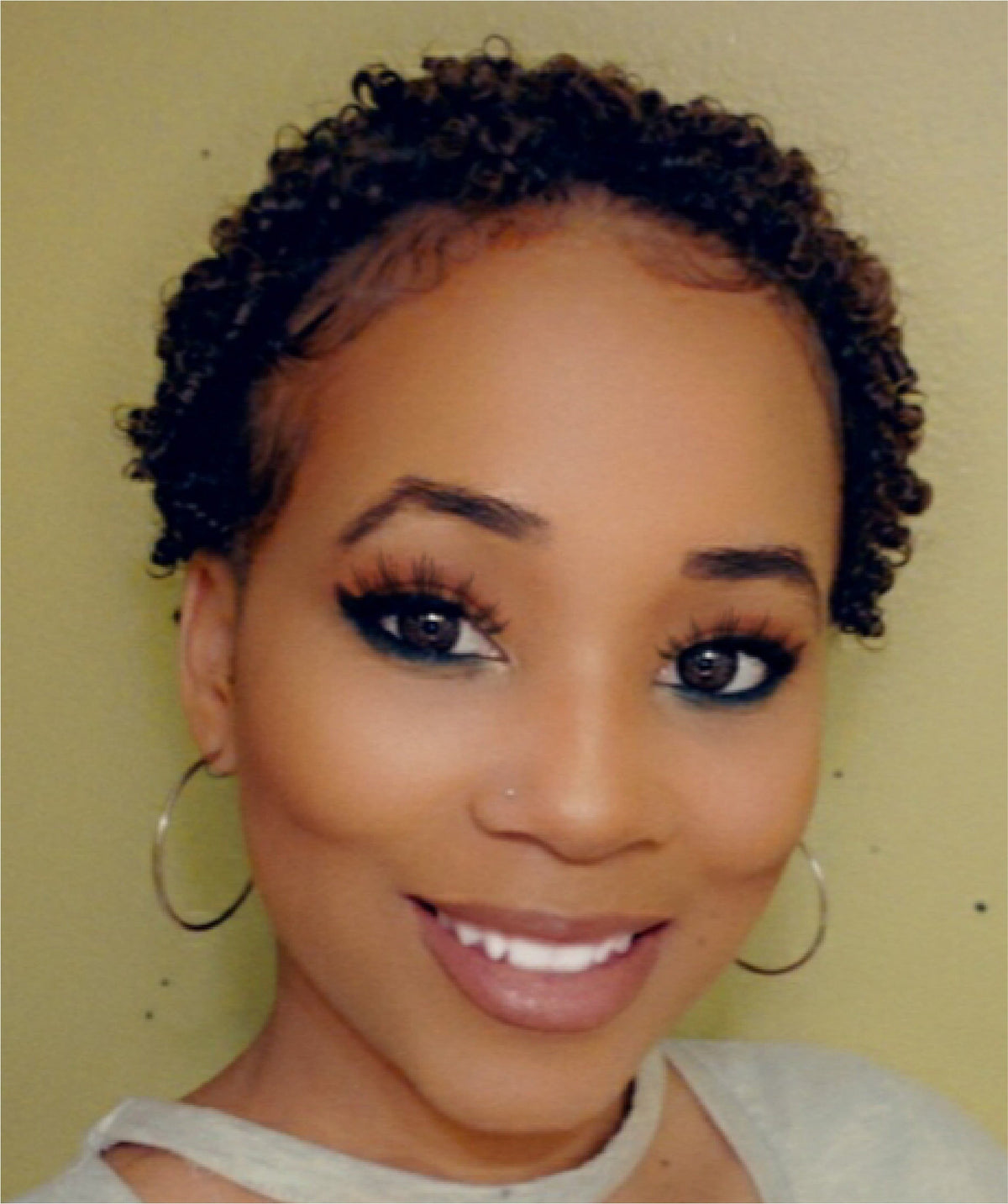 Picture of Tania Banks smiling with a short natural curly style.