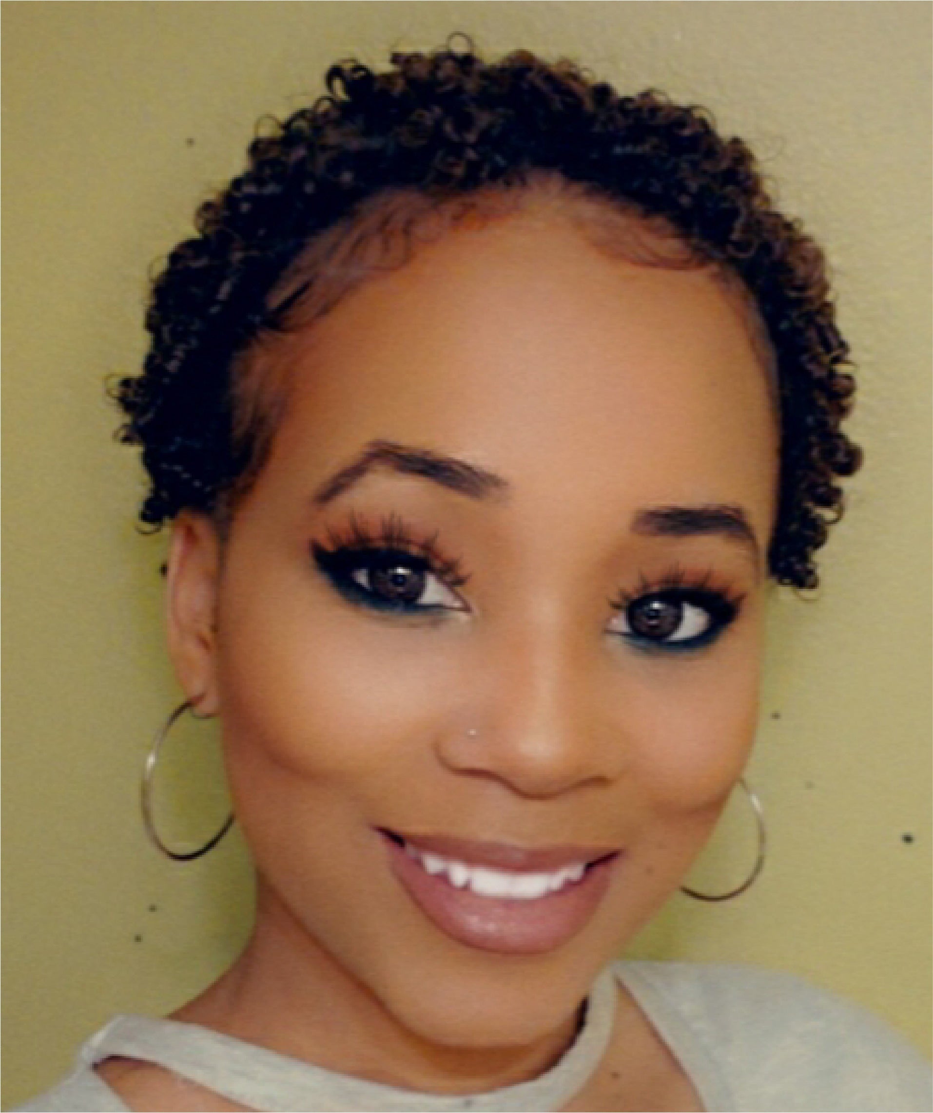 Picture of Tania Banks smiling with a short natural curly style.