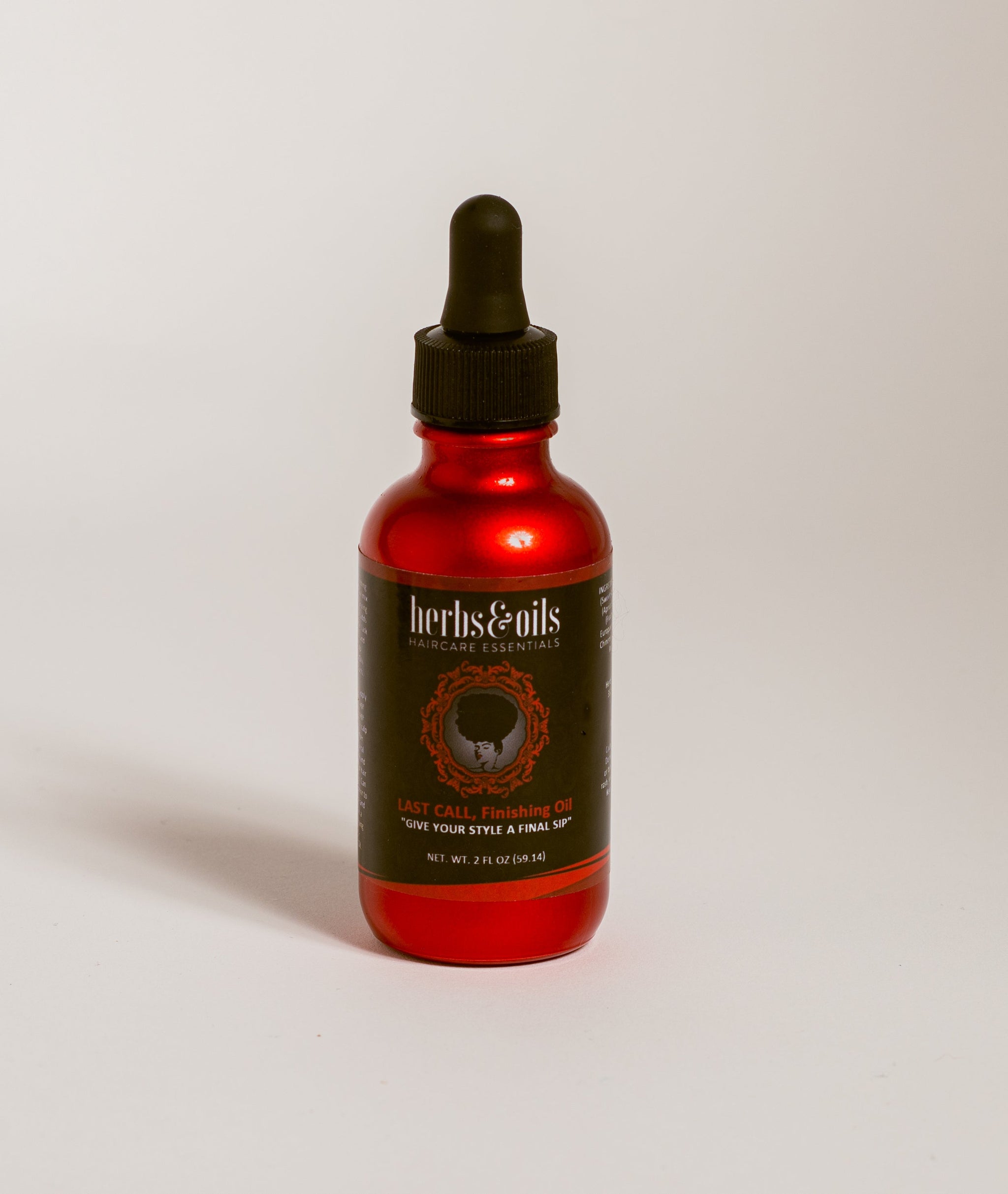 Herbs and Oils, Last Call Finishing Oil in a red, shiny, glass bottle with black dropper top with the company logo on the front of the bottle.