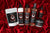 Picture of the full line of herbs and oils haircare essentials products on a red velvet cloth that makes the product stand out beautifully.  Highlighting that these products are the best all natural products on the market.